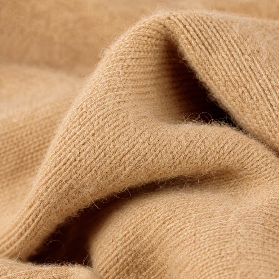 Macro photograph of camel cashmere knit.