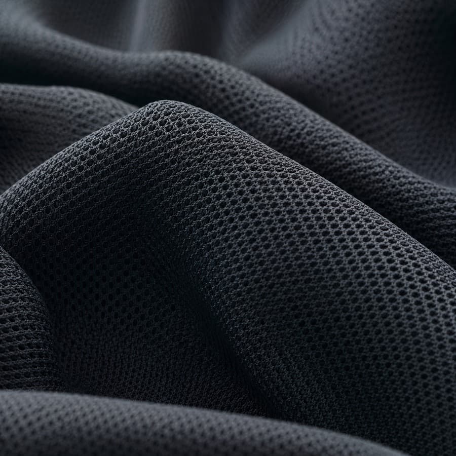 Macro photograph of dark technical performance mesh.