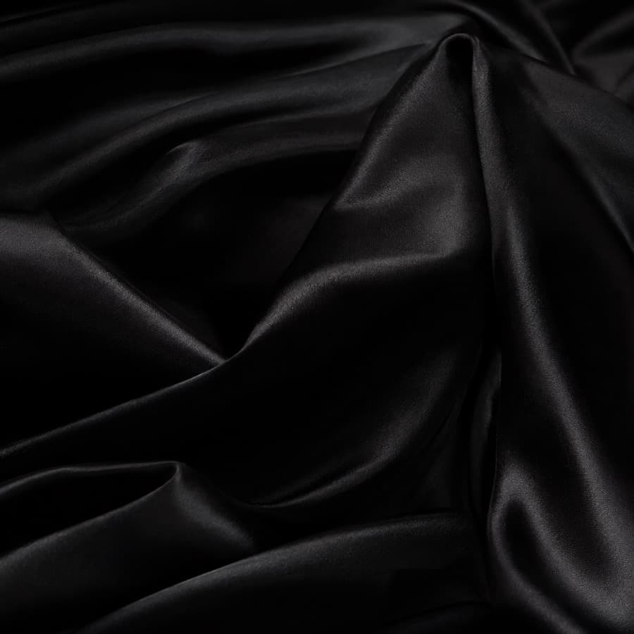 Macro photograph of black viscose satin lining.