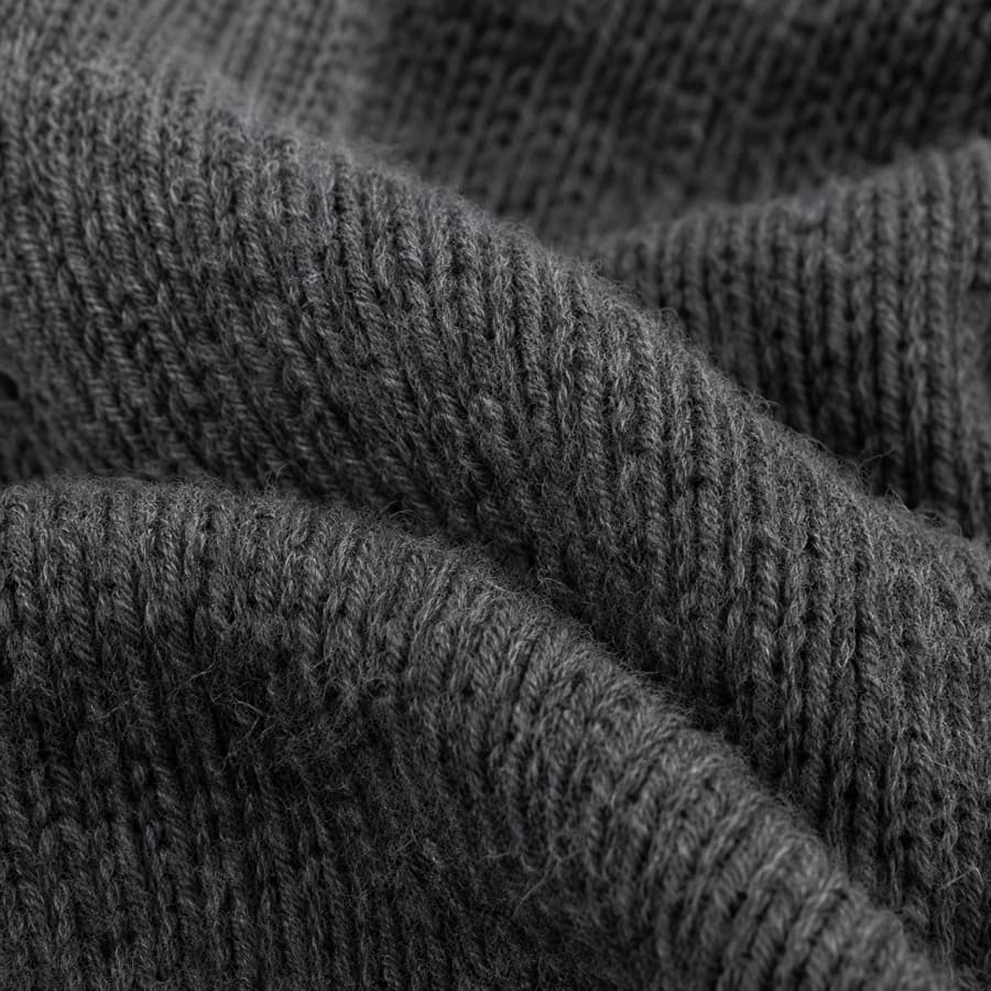 Macro photograph of charcoal merino wool knit.